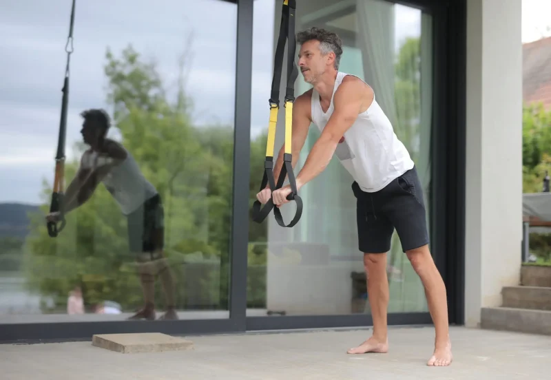 A low angle shot of a European male person working out at home during lockdown
